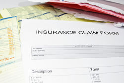 Picture of papers with INSURANCE CLAIM FORM written.
