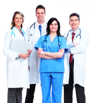 Picture of four smiling medical personnel (two females and two males). One person in scrubs and three in lab coats.
